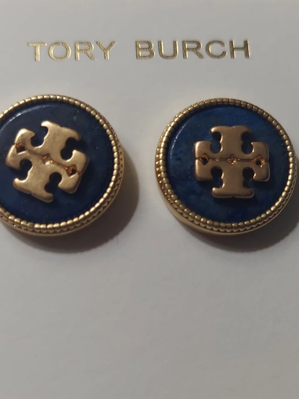 Tory Burch Kira semiprecious stud earrings feature a navy blue lapis stone.